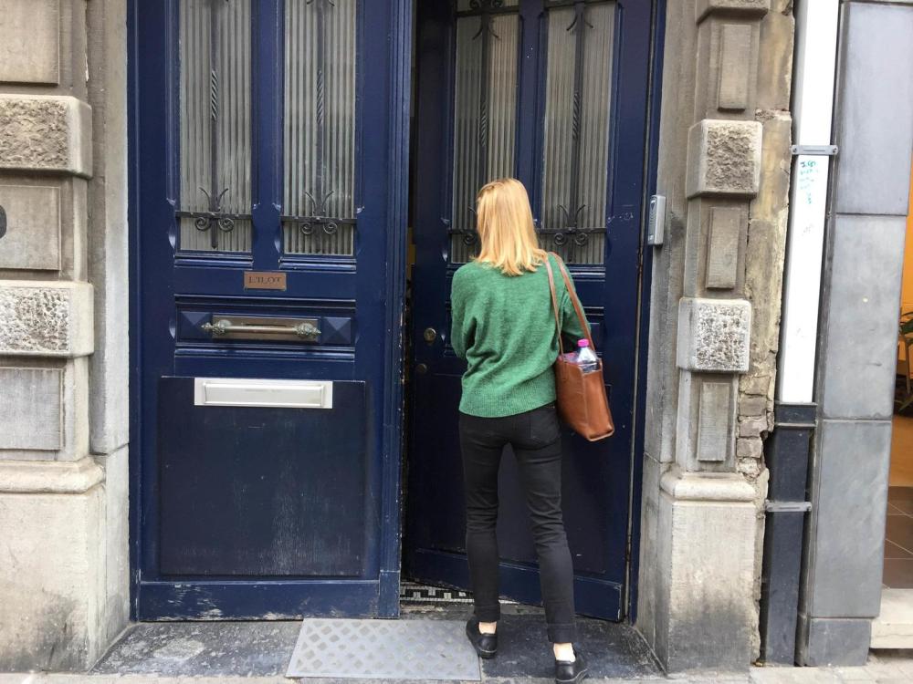 A woman entering a door