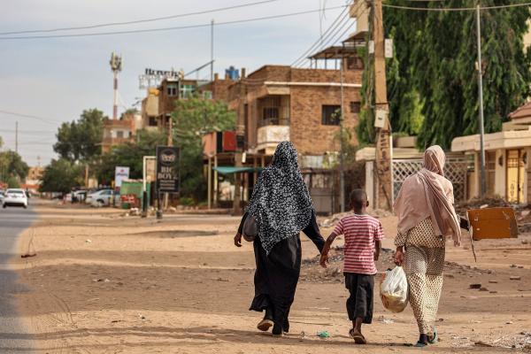 Women and a boy walk along a street in Khartoum on April 18, 2023. Explosions rocked the Sudanese capital Khartoum on April 18, the fourth day of fighting. © AFP via Getty Images.