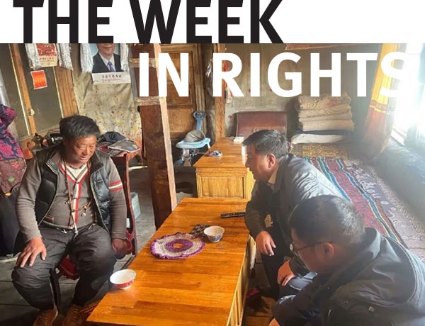 Three individuals gather around a table in Tibet. 