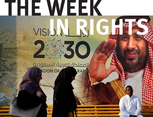  People walk past a Vision 2030 banner showing Saudi Crown Prince Mohammed bin Salman, Jeddah. 