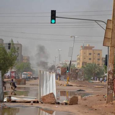 Smoke rises behind barricades laid by protesters in the Sudanese capital Khartoum on Wednesday, June 5, 2019.