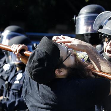 A protester is hit with a baton by San Jose police, Friday, May 29, 2020, in San Jose, California, as more demonstrations take place nationally after George Floyd died in police custody on Memorial Day.