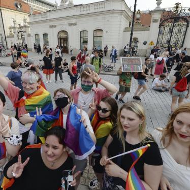 People with Rainbow flags dance as they take part in a rainbow disco flashmob in front of the Presidential Palace in Warsaw, Poland, Thursday, June 11, 2020. Polish President Andrzej Duda had signed a homophobic and discriminating document called Family Card. 