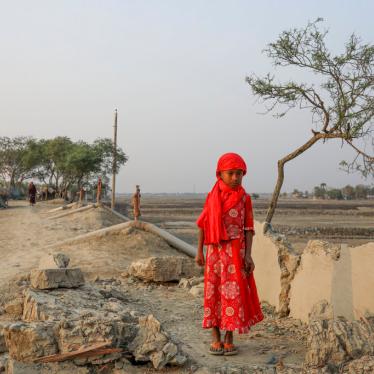 A girl surrounded by land devastated by Cyclone Amphan in Satkhira