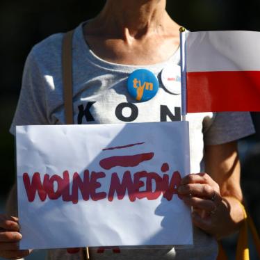 A woman holds a sign with the words "Free media" in Warsaw, Poland on August 11, 2021.