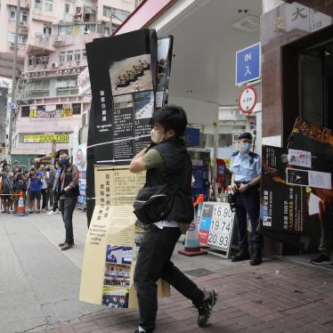 Police officers take away an exhibit from the June 4th Museum in Hong Kong. Thursday, Sept. 9, 2021.