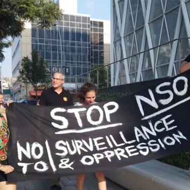 People holding sign to stop NSO