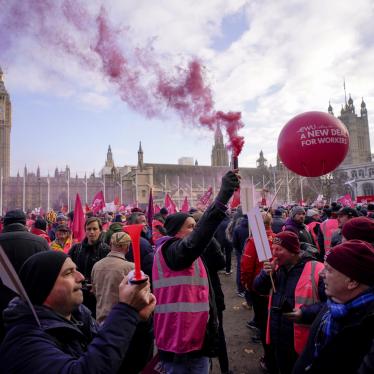 Royal Mail workers hold placards and banners as they gather in Parliament Square.