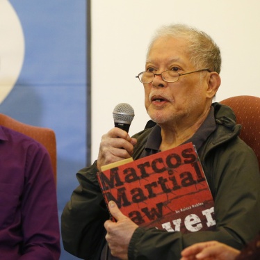 Human rights lawyer and former senator Rene Saguisag holds a copy of a book about the martial law period in the Philippines while describing his ordeal in detention, Manila, September 26, 2018. 