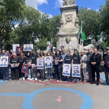 Victims’ and families’ associations gathered next to the Paris Criminal Court on May 21, 2024, holding photos of relatives who have been detained or disappeared in Syria. 