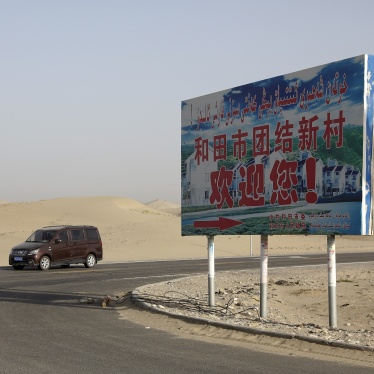 A signboard reads "Welcome to Hotan Unity New Village" in Hotan, Xinjiang, September 21, 2018. 
