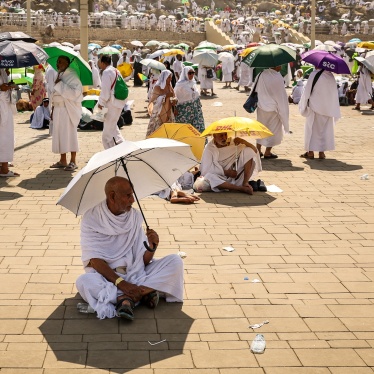 Pilgrims use umbrellas to shade themselves from the sun as they arrive at the base of Mount Arafat, also known as Jabal al-Rahma or Mount of Mercy, during the annual hajj pilgrimage on June 15, 2024. 