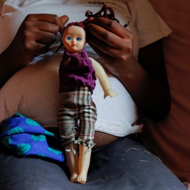 A secondary school student who is pregnant holds a doll inside her home in the Kibera slums of Nairobi, Kenya on September 30, 2020. (
