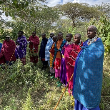 A group of Maasai women and men in traditional Maasai clothing and jewelry