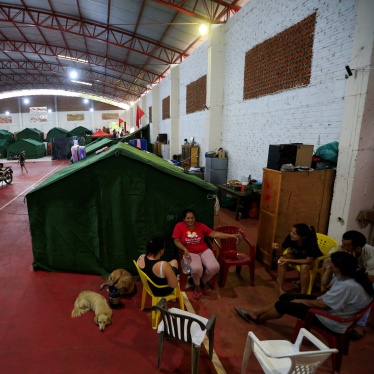 Displaced residents chat on a school court used as a temporary shelter after the Parana river overflowed its banks due to heavy rain upstream, in Ayolas, Paraguay November 8, 2023.
