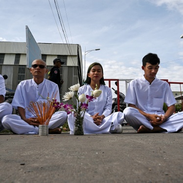 Cambodian environmental activists from the group Mother Nature sit near barricades blocking a street to the municipal court in Phnom Penh, Cambodia, June 5, 2024.