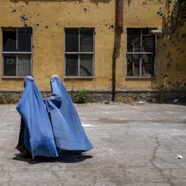 Afghan women wait to receive food rations distributed by a humanitarian aid group, in Kabul, Afghanistan, on May 28, 2023.