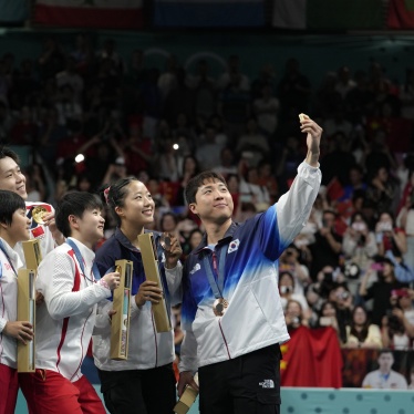 South Korea's Lim Jong-hoon, right, takes a selfie with other table tennis Olympians, including North Korea's Ri Jong Sik, left, and Kim Kum, second left, during the medal ceremony at the 2024 Summer Olympics in Paris, France, July 30, 2024.