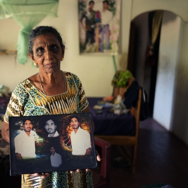 Soosai Victoria shows photographs of her missing son at her home in Mullaitivu, Sri Lanka, May 7, 2024. 