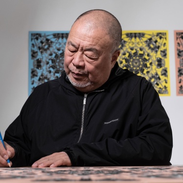 Artist Ai Wei Wei signs a lithograph print