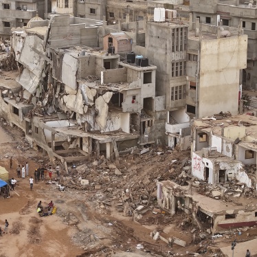 Rescuers and relatives of victims set up tents in front of collapsed buildings in Derna, Libya, September 18, 2023.