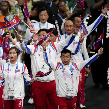 Athletes in uniform wave flags 