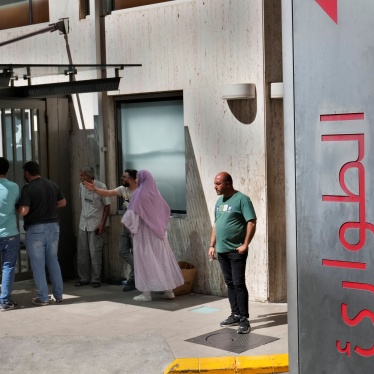 People stand outside a hospital emergency room