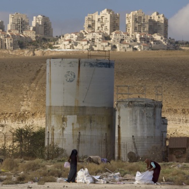 People collect scrap timber in the Mishor Adumim industrial zone near the Israeli settlement of Maaleh Adumim, November 22, 2010.