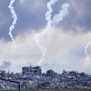 Smoke billows after an Israeli strike as flares are also dropped over north Gaza, November 22, 2023.