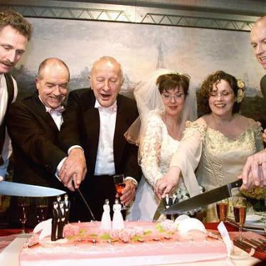 Peter Lemke, Frank Wittebrood, Ton Jansen, Louis Rogmans, Helene Faasen, Anne-Marie Thus, Dolf Pasker and Geert Kasteel cut the cake after their wedding ceremony in the town hall of Amsterdam on April 1, 2001.