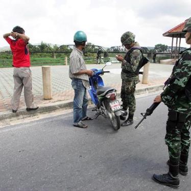 Thai soldiers check documents of local residents as they man a checkpoint in the central Yala province, south of Bangkok on January 25, 2010. 