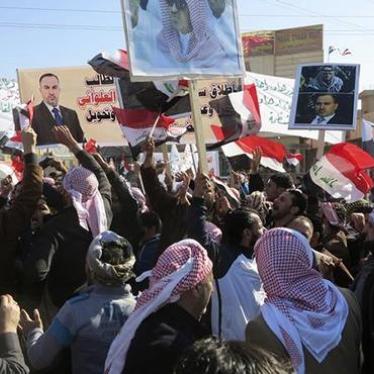 People shout slogans while holding placards, banners and national flags, during a demonstration asking for the release of Sunni lawmaker Ahmed al-Alwani in Ramadi, Iraq on January 25, 2014.