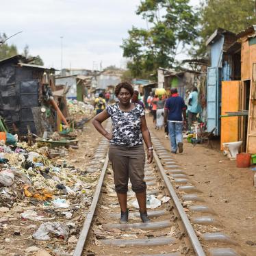 Jaqueline Mutere, 48, walks on a rail line in Kibera, the largest slum in Kenya, which was one of the hotspots of the post-election violence. 