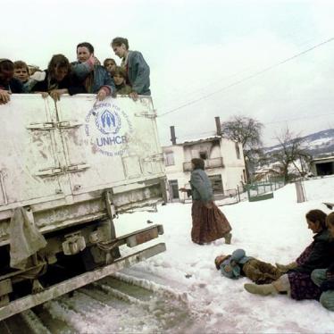 A wounded Muslim boy lays in the snow next to an overloaded UNHCR truck March 31, 1993 during evacuation from besieged Srebrenica as part of an agreement between Serbs, Muslims and the commander of UN peace keeping forces in Bosnia.
