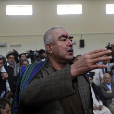 Abdul Rashid Dostum talks with his supporters at the Afghanistan's Independent Election Commission (IEC) in Kabul, Afghanistan, October 6, 2013.