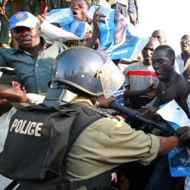 A Ugandan riot policeman uses his weapon to push back protesting supporters of opposition Forum for Democratic Change (FDC) leader Kizza Besigye in Kampala, Uganda, February 20, 2006.