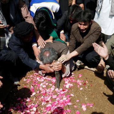 Afghan Shia Muslims men mourn over the grave of a victim who was killed in Tuesday's attack at the Sakhi Shrine in Kabul, Afghanistan October 12, 2016.