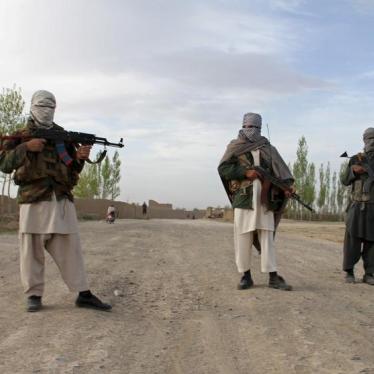 Members of the Taliban stand at the site of the execution of three men in Ghazni Province April 18, 2015.