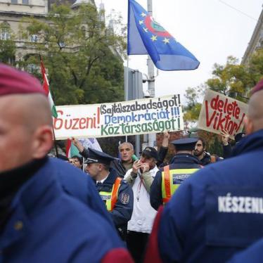 Hungarian police stand guard in front of anti-government protesters near to a ceremony marking the 60th anniversary of 1956 anti-Communist uprising in Budapest, Hungary, October 23, 2016.