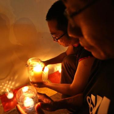 Anti-death penalty activists place candles outside Changi prison in Singapore December 2, 2005.