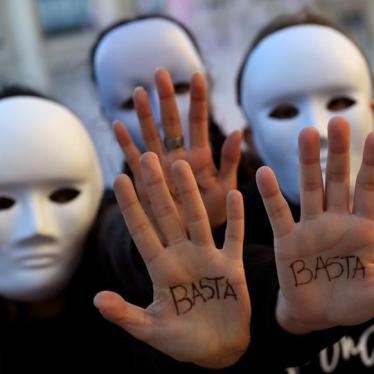 Gender studies students wearing masks pose with the word "Enough" written on their hands during a performance to commemorate victims of gender violence, during the U.N. International Day for the Elimination of Violence against Women, in Oviedo, Spain Nove
