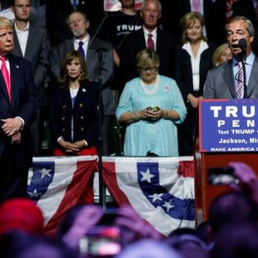 Republican presidential nominee Donald Trump watches as Member of the European Parliament Nigel Farage speaks at a campaign rally in Jackson, Mississippi.