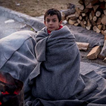 A Syrian boy wakes up after spending a freezing night sleeping outside at a petrol station near the Greek border with Macedonia. January 29, 2016.
