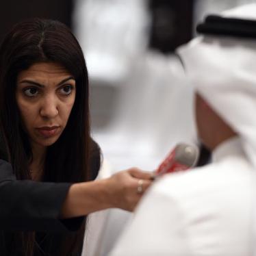 Bahraini journalist Nazeeha Saeed conducts an interview in Manama, Bahrain, August 26, 2014. © 2014 EPA
