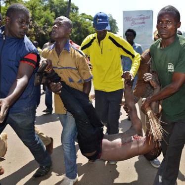 Protestors carry an injured man after he was shot by police in the western city of Kisumu, Kenya, during demonstrations by opposition supporters on June 6, 2016. 