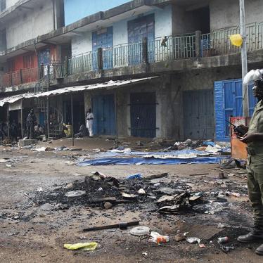 A security officer stands in the Madina market in Conakry, Guinea, following clashes between rival political party supporters on October 9, 2015.