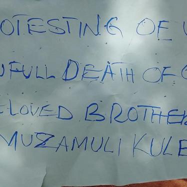 A protestor holding a poster held in memory of Kule Munyambara Obed, who was allegedly shot by the Ugandan military in Kasese district on April 3, 2016.
