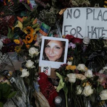 A photograph of Heather Heyer is seen amongst flowers left at the scene of the car attack on a group of counter-protesters on August 12, 2017 that took her life in Charlottesville, Virginia, August 14, 2017. 