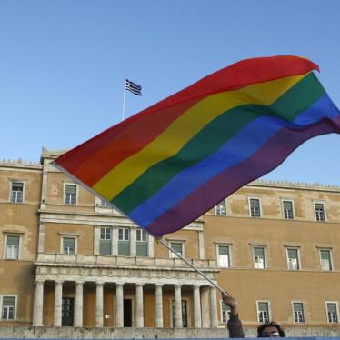A protestor waves a rainbow flag during a gay protest outside the Greek parliament in Athens September 29, 2008.
