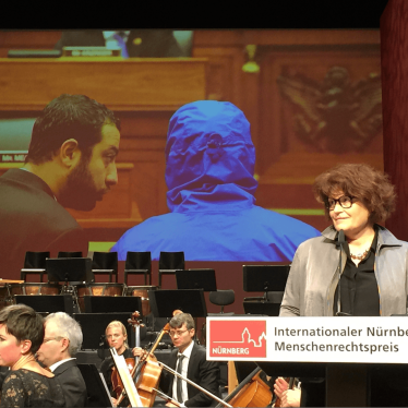 Garance Le Caisne, author of the book "Opération César: Au coeur de la machine de mort syrienne" (Operation Caesar. In the Heart of the Syrian Death Machine), accepting the award on behalf of “Caesar” and his group of collaborators. The hooded man project